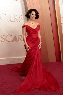 Raye at the Oscars in a red gown.
