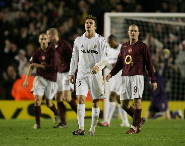 David Beckham in a white Real Madrid uniform looking up in despair after his team was knocked out of the UEFA Champions League.