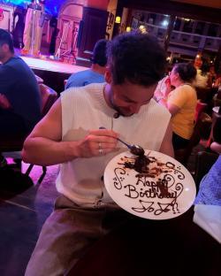 Person eating a birthday dessert.