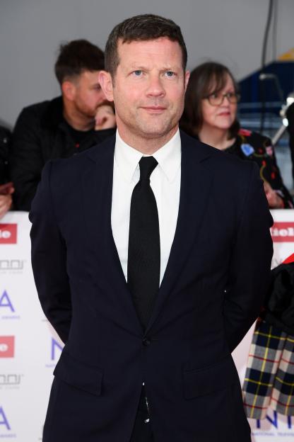 Dermot O'Leary in a dark suit with a white shirt and black tie at the NTA's 2025.