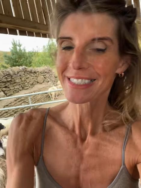 Amanda Owen smiling near sheep.