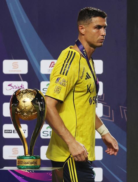 Cristiano Ronaldo with a medal after a soccer match.