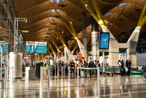 Passengers waiting at Madrid-Barajas Airport Terminal 4.