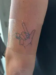 Tattoo of a hand making the