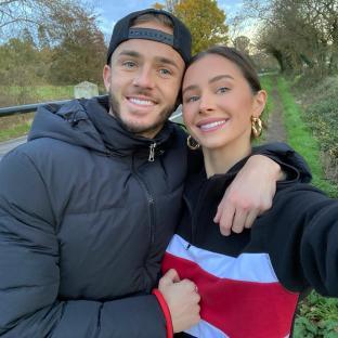 Couple posing for a selfie outdoors.