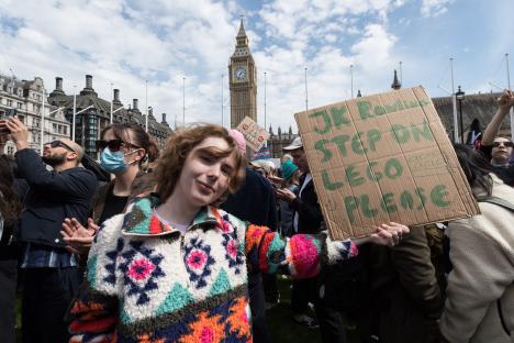 Protestor at a trans rights demonstration holding a sign that says 