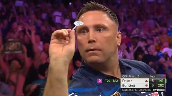 A darts player aiming at the board.