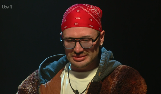 Man wearing a red bandana and glasses.