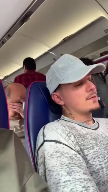 A plane passenger realizing he's sitting behind Katie Price.
