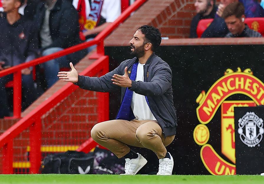 Manchester United manager Ruben Amorim coaching during a game.