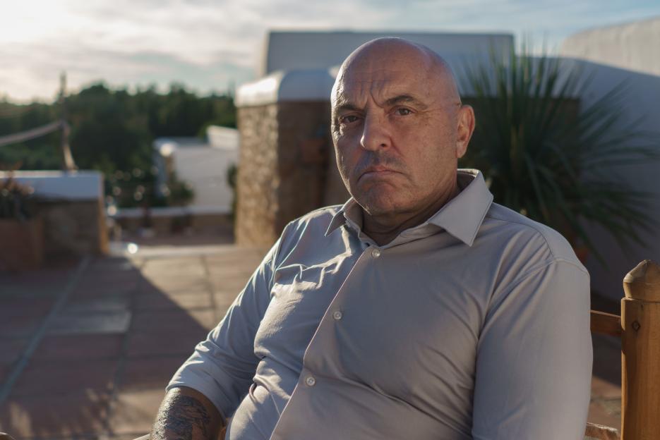 Portrait of a man in a light gray shirt.