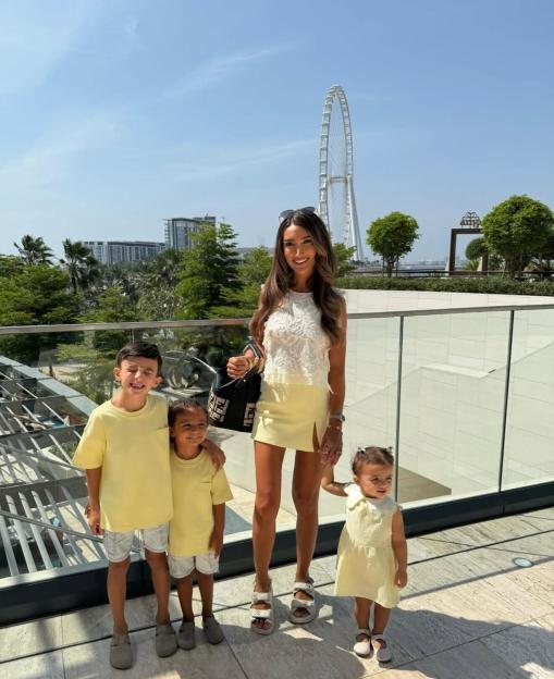 Woman and three children in yellow outfits in Dubai.