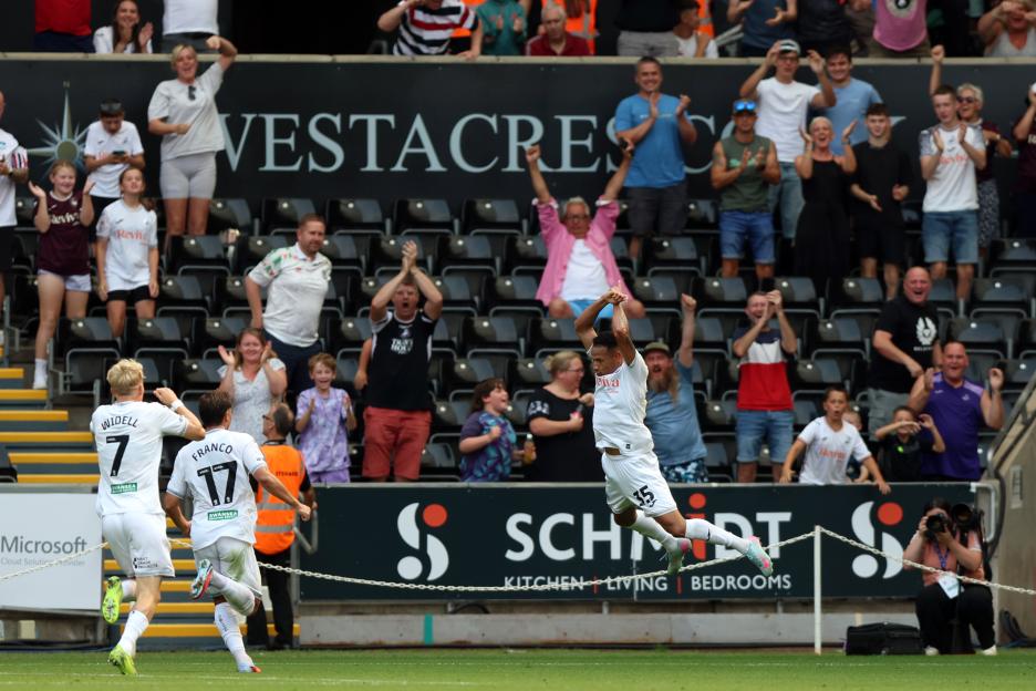 Soccer player celebrates scoring a goal.