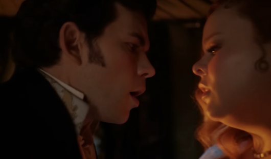 Colin and Penelope in a carriage from Bridgerton.