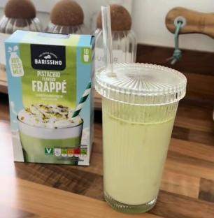 Pistachio frappe in a glass with a box of frappe mix.