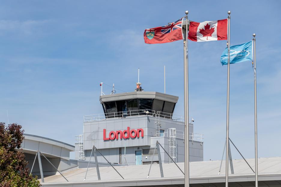 London International Airport air traffic control tower with flags.