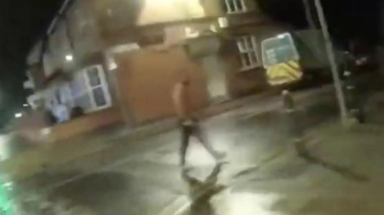 Terrifying moment topless knifeman lunges at cops with blade after biting man’s EAR off in robbery gone wrong