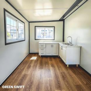 Interior of a Green Swift tiny home, showing a small kitchen and bathroom.