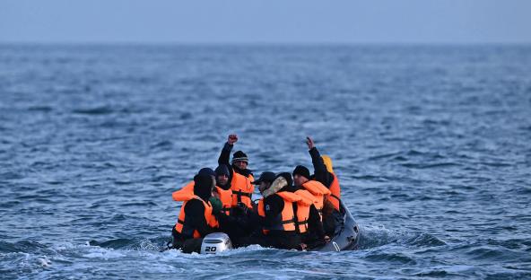 Migrants in a small inflatable boat crossing the English Channel.