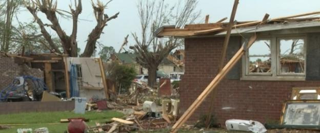 Damaged house after a tornado; couple hospitalized.