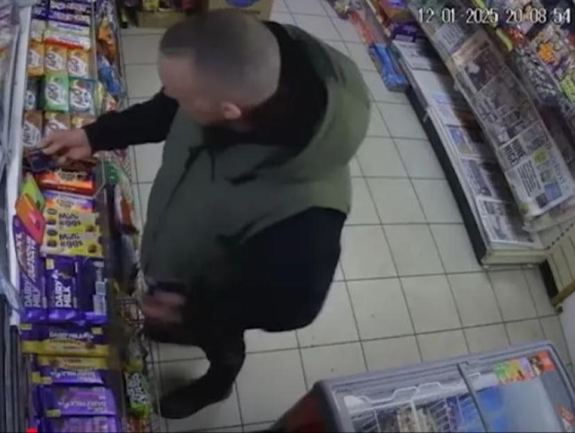 CCTV image of a man in a shop.