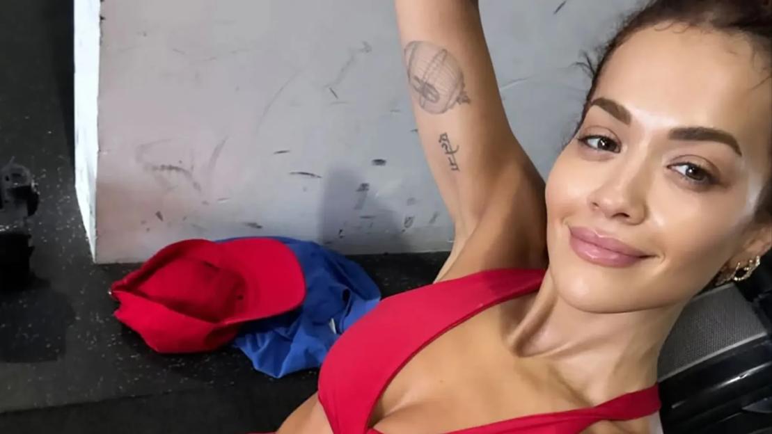 Rita Ora shows off her washboard abs in red bra and shorts as she joins other stars in flashing toned physique