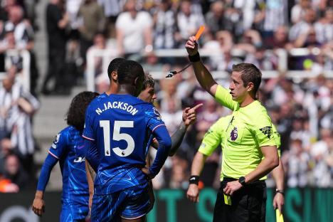 Referee showing a red card to a soccer player.
