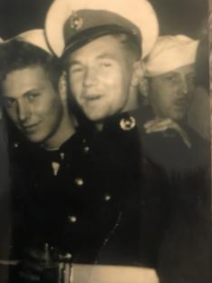 Black and white photo of three servicemen in uniform.