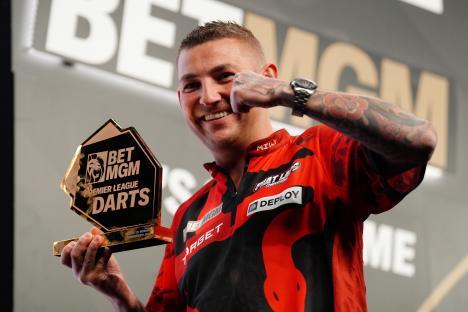 Nathan Aspinall celebrates winning the BetMGM Premier League Darts trophy.
