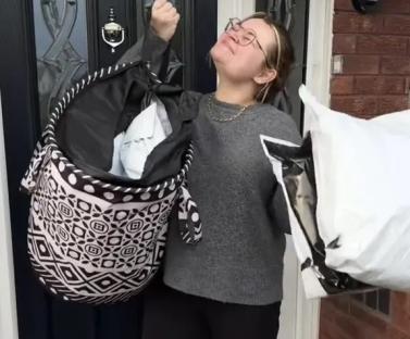 Woman holding bags of clothes, showing £450 profit from reselling on Vinted.