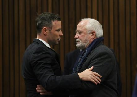 Oscar Pistorius embracing his father in court.
