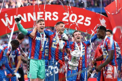 Crystal Palace players celebrating with the Emirates FA Cup trophy.