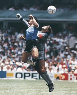 Photo of Diego Maradona scoring a goal with his hand during a 1986 World Cup quarterfinal match.