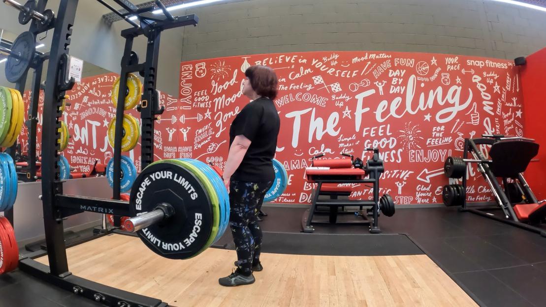 Woman weightlifting in a gym.
