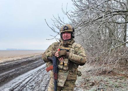 Dmitry Rogozin, a close Putin ally, holding a rifle.