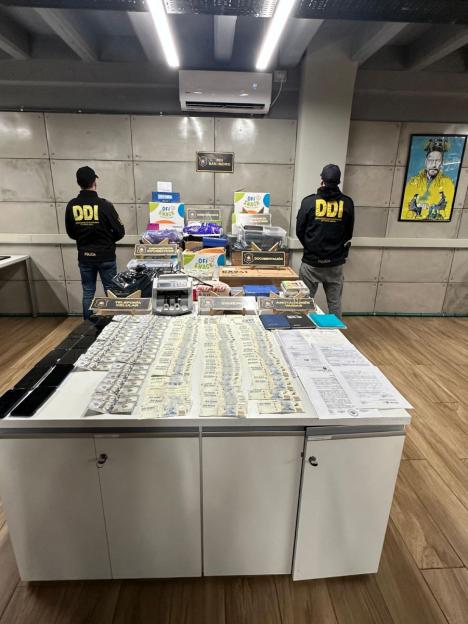Seized cash and equipment from an illegal streaming operation.