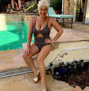 Woman in a swimsuit by a pool.