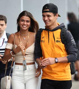 Lando Norris and Luisinha Barosa Oliveira at a racetrack.