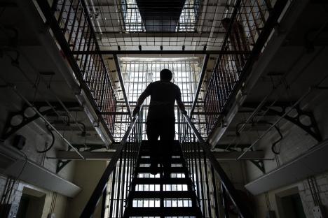 Person ascending a staircase inside Reading Prison.