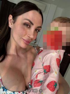 Liana Isadora Van Riel holding a baby.