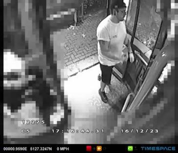 Security camera image of a man getting off a bus.