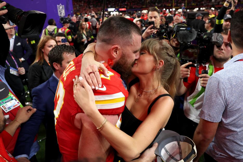 Travis Kelce and Taylor Swift embracing after the Super Bowl.