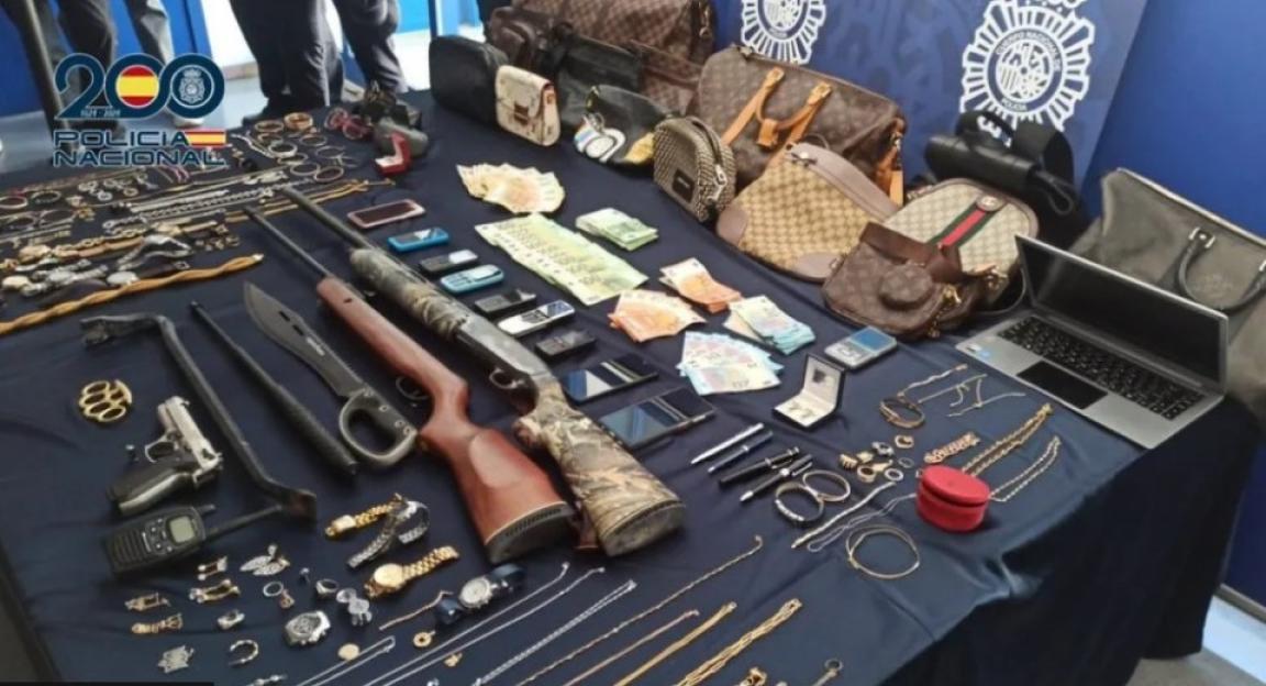 Seized contraband: weapons, jewelry, cash, electronics, and designer bags.