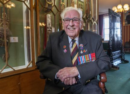 100-year-old army veteran, Richard Brock, wearing medals.