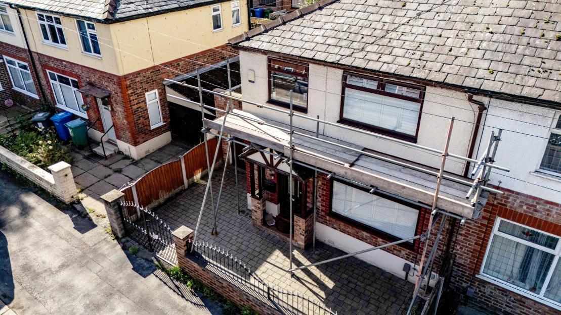 Aerial view of a house with scaffolding.