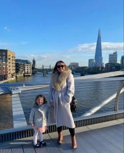Woman and child on a bridge in London, with the Shard in the background.