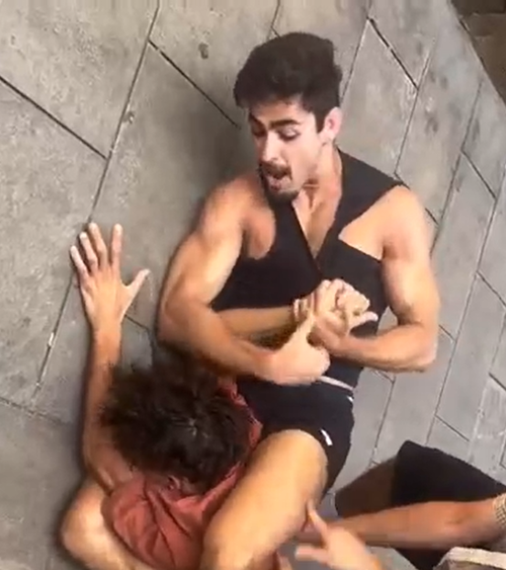 Man holding another man in a wrestling hold.