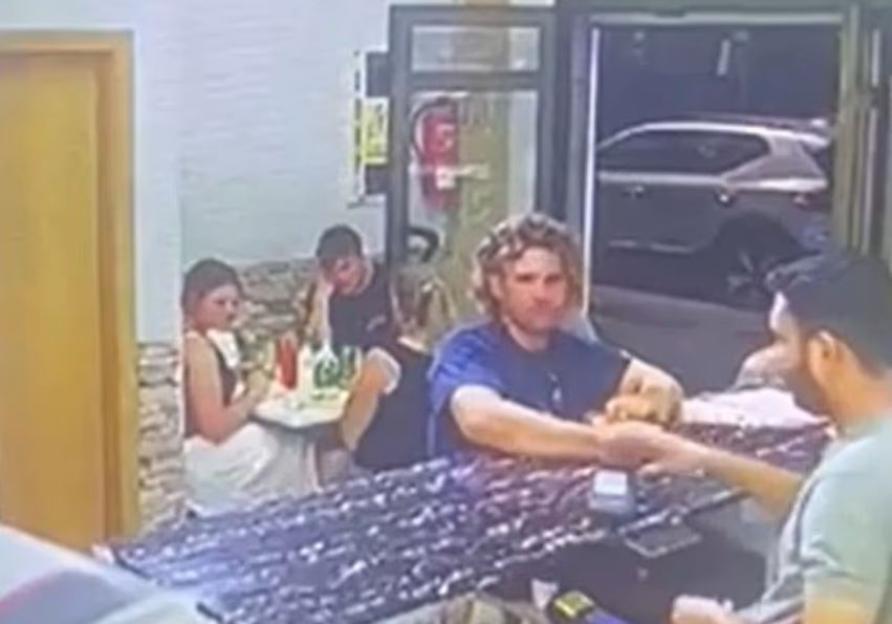 CCTV footage of James Nunan at a kebab shop counter in Gran Canaria, with customers seated at tables behind him.
