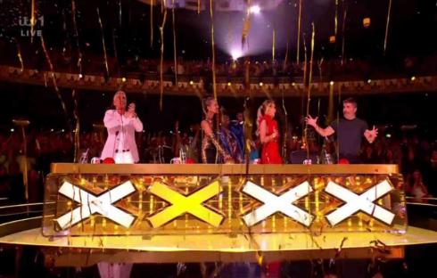 Britain's Got Talent judges at the judges' table with confetti falling.