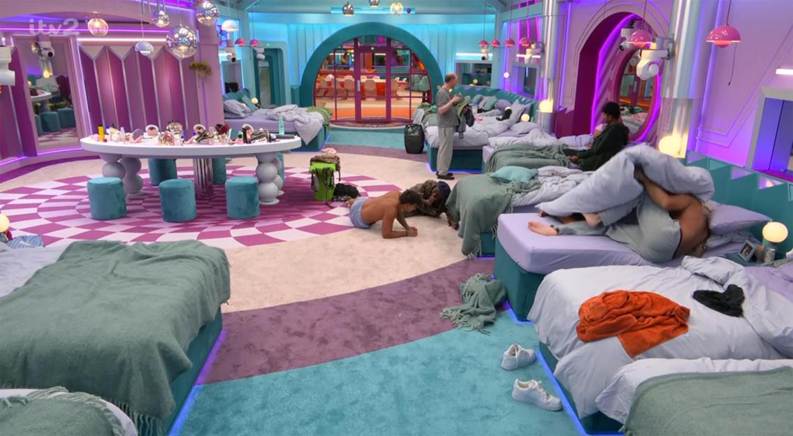 People in a Big Brother bedroom with colorful decor.